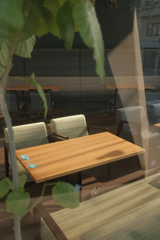 a restaurant table and chairs with a clock on the wall