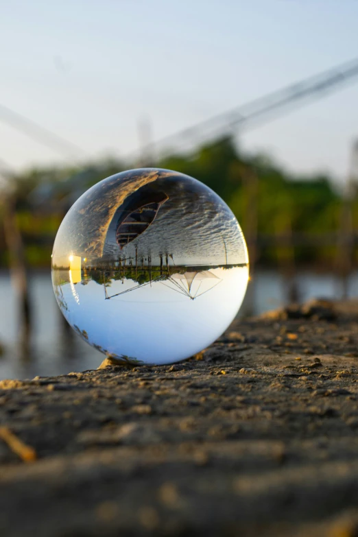 a clear glass ball sitting on the ground