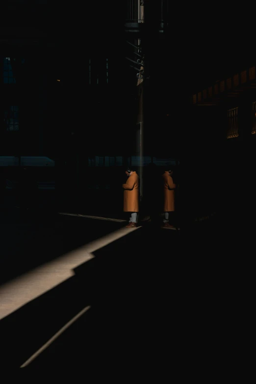 the image of a person walking through the dark streets at night