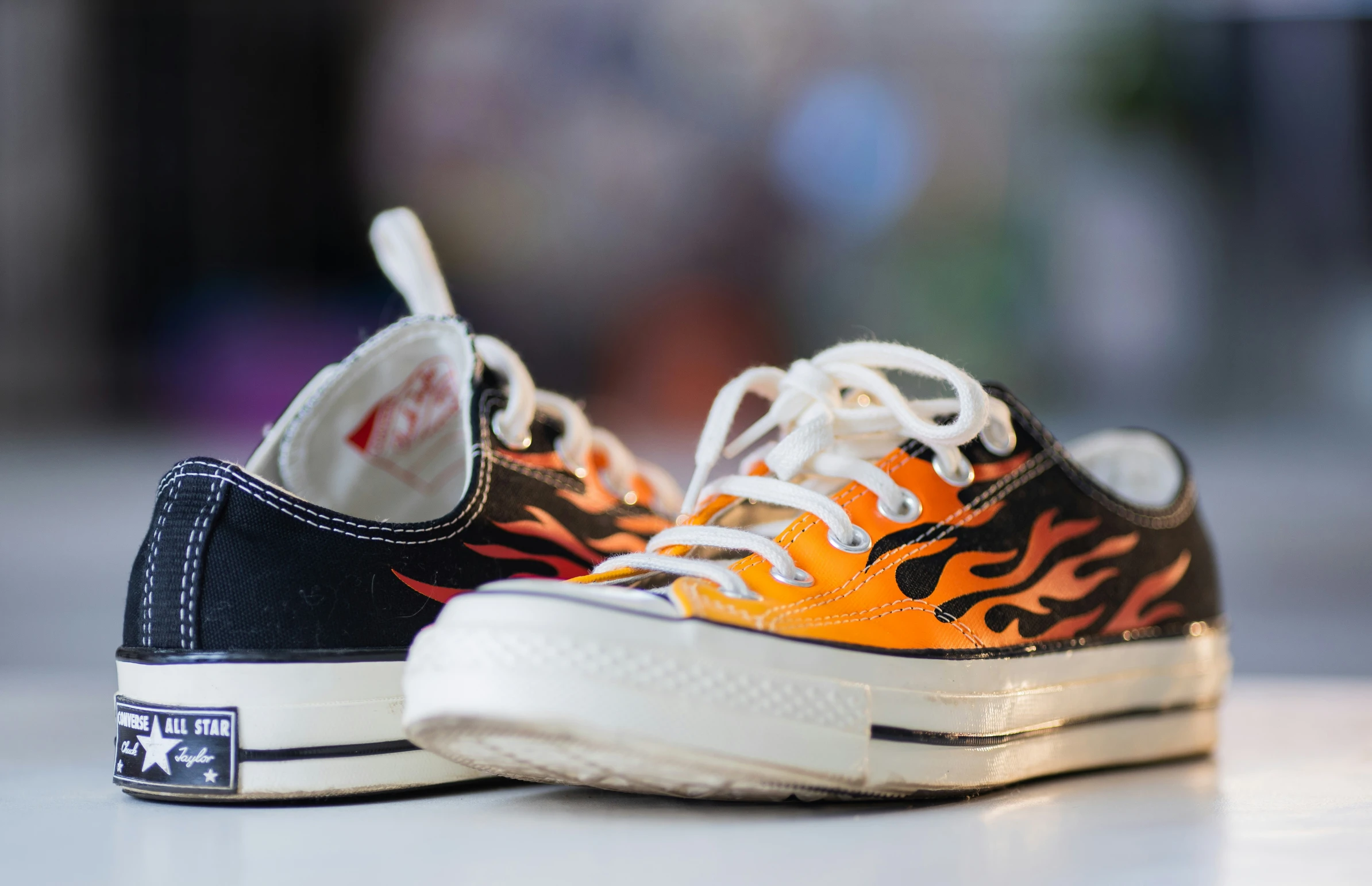 this is an orange and black flames design sneaker