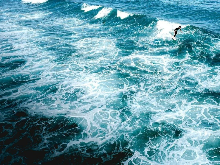 a person on a surfboard riding the crest of a wave