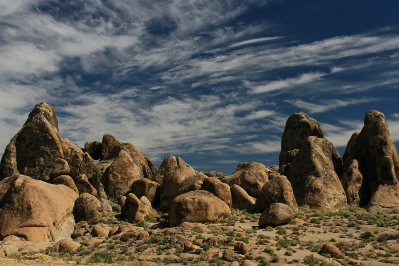 a bunch of rocks and boulders against the blue sky