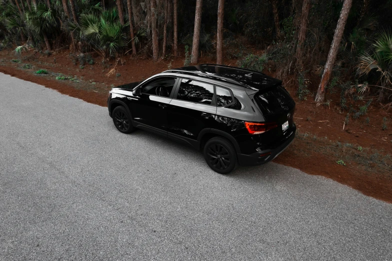 an image of a black car driving down a road