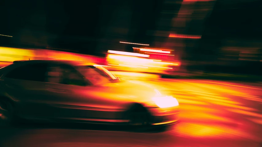 a car that is sitting on a road in the dark