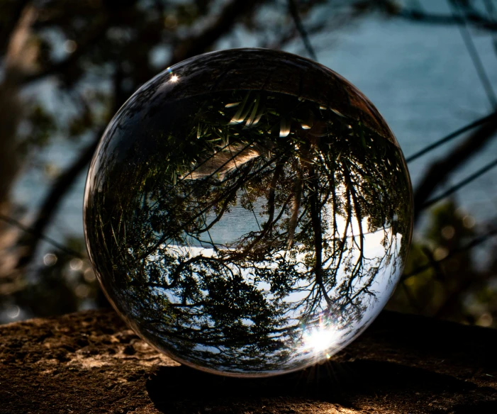 looking up into the sky and through the glass ball