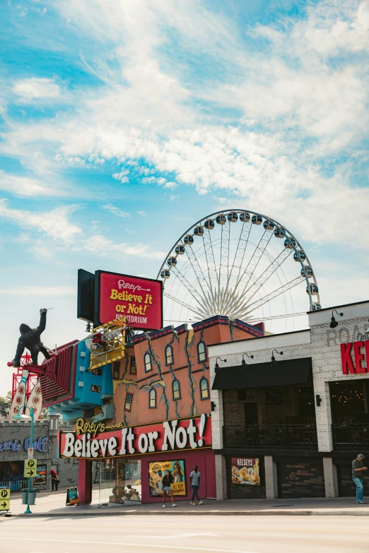 a carnival has been decorated in front of a large ferris wheel