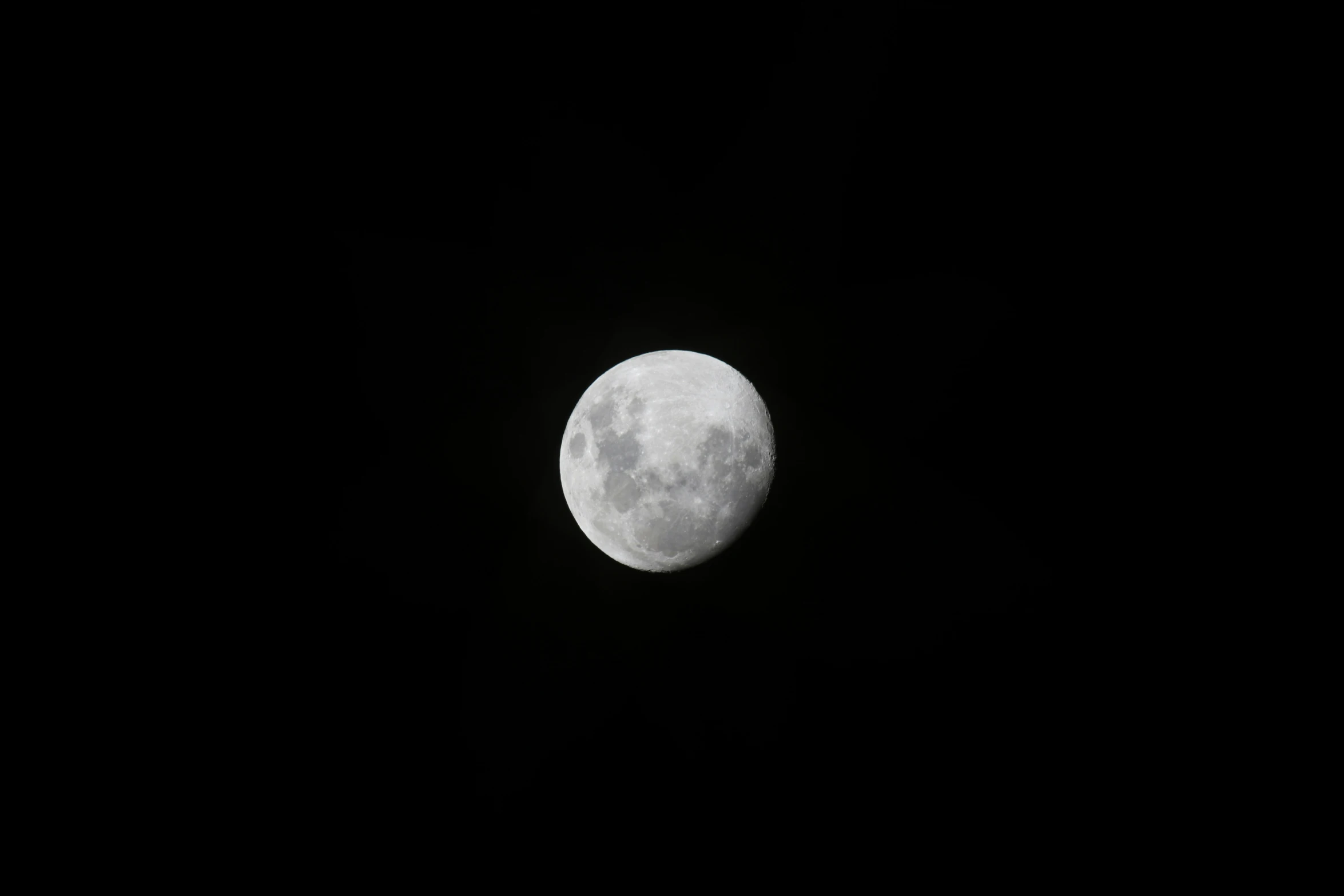 the bright white half moon is on the night sky