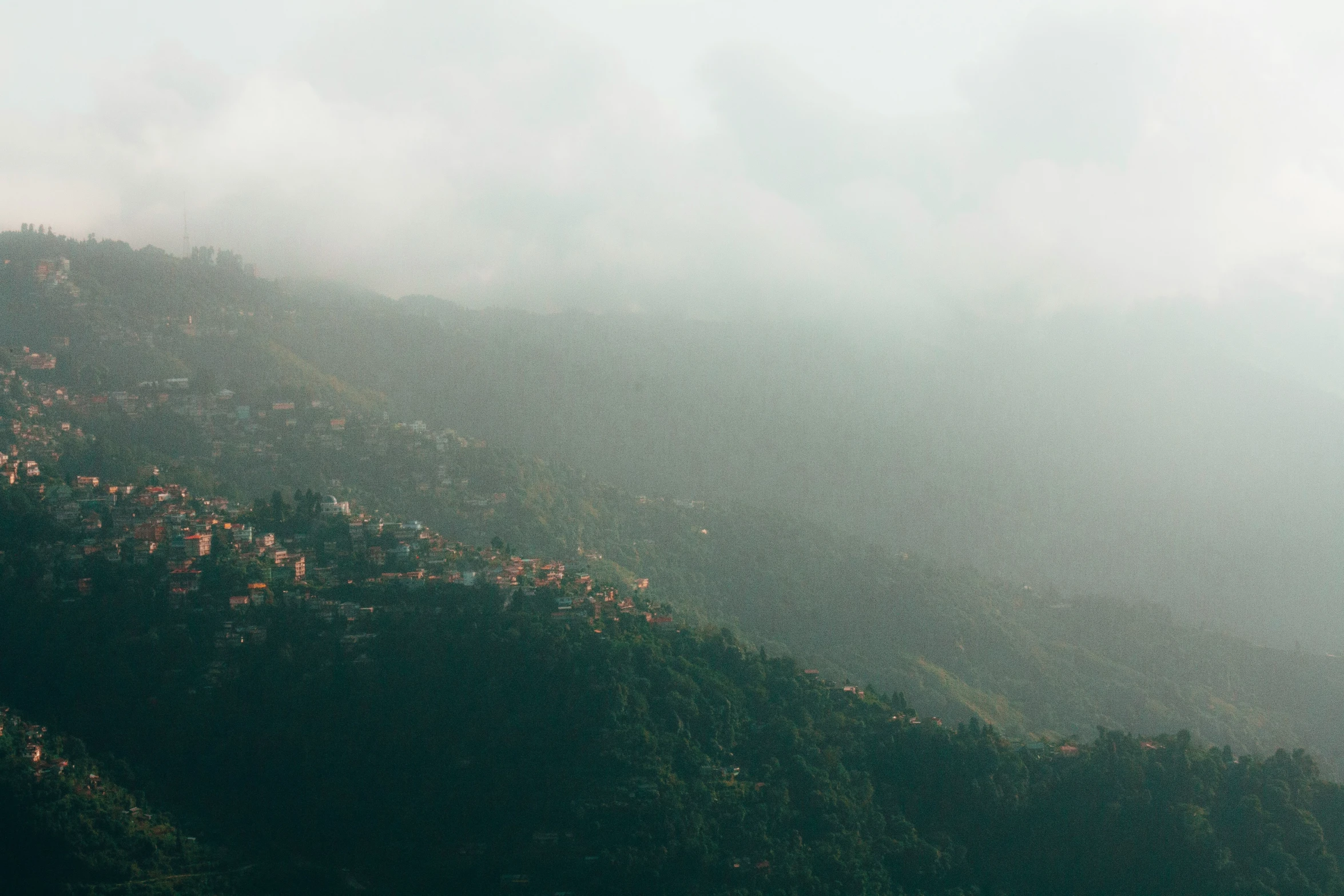 the view from the top of a mountain in the rain