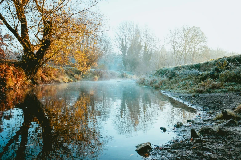 a small river with a reflection in the water