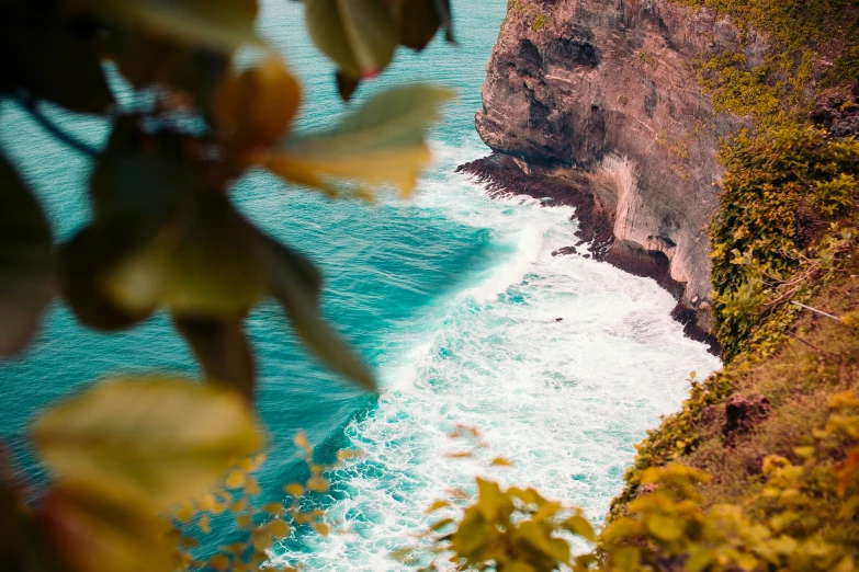 an aerial view of water and cliffs at a beach