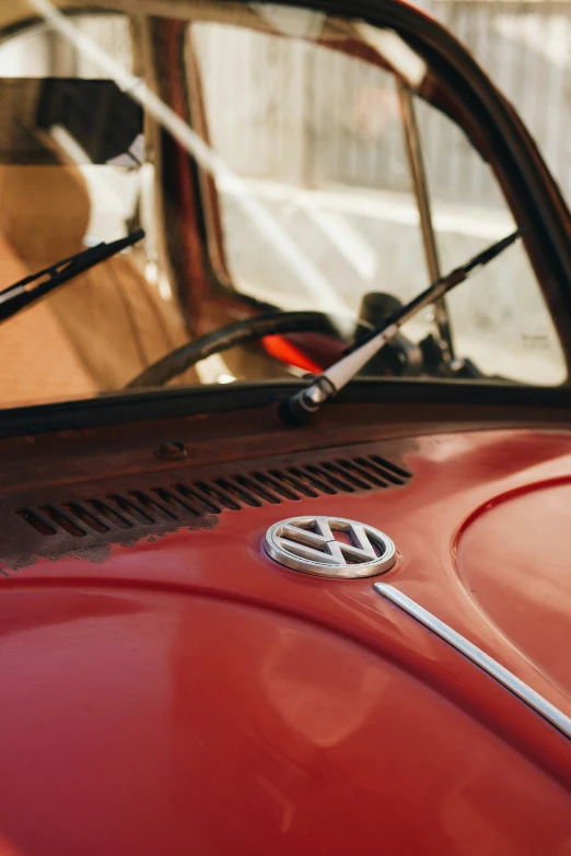 the emblem of a red car is seen