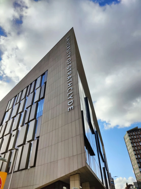 the facade of a building with sky and clouds