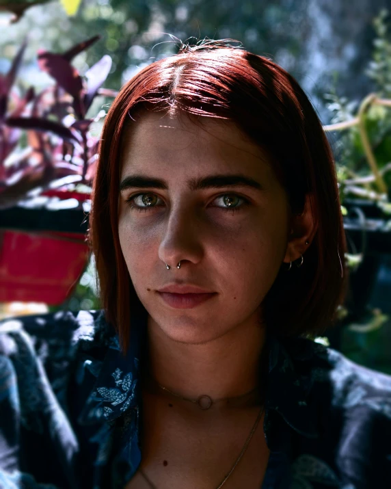 a girl with short hair standing against the sun