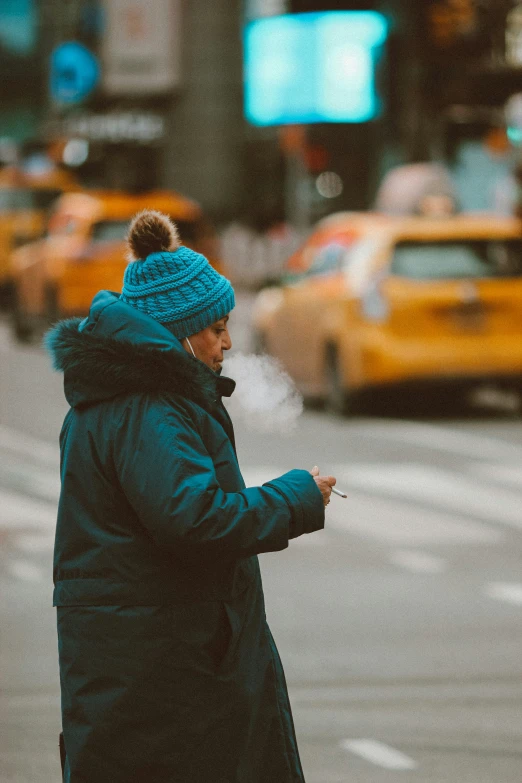 a woman walking down a street using a cellphone