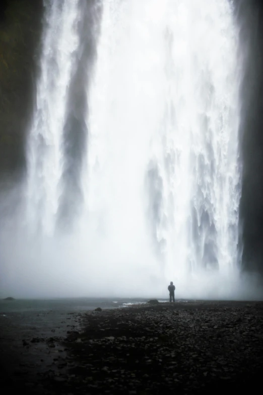 a man that is standing in front of some water