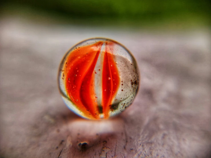 a glass marble with a red stripe under it