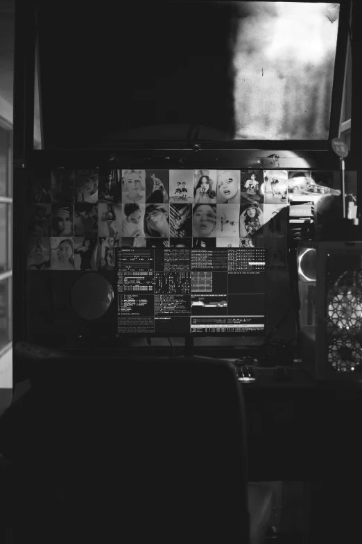 a wall covered with pos and posters in a room