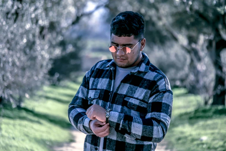 a man looking at his cell phone in the park