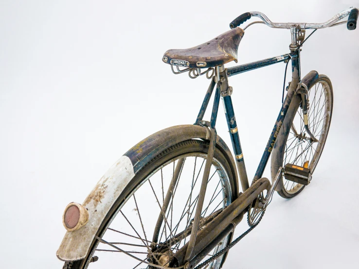 an old bicycle has been rusted and scratched down