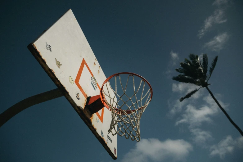 an old basketball hoop hanging from the side of an old basketball hoop