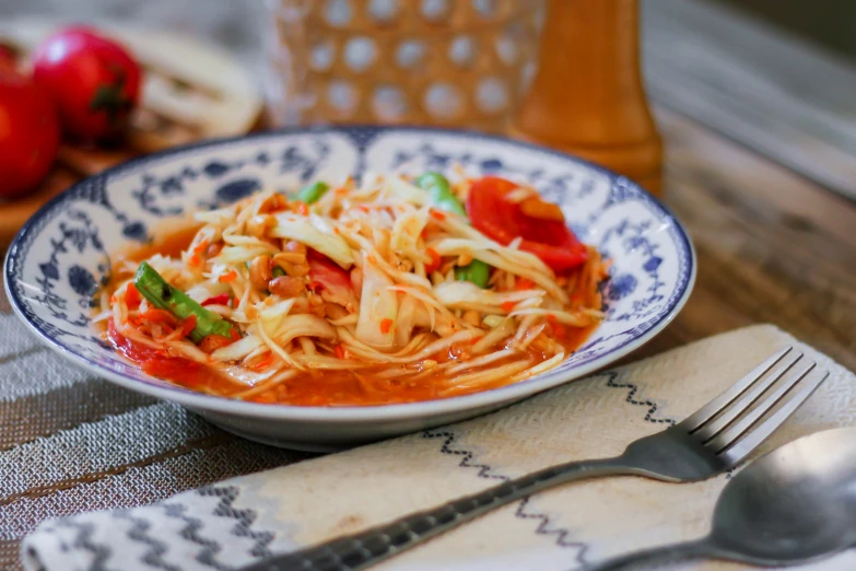 a bowl of vegetable spaghetti with parmesan cheese