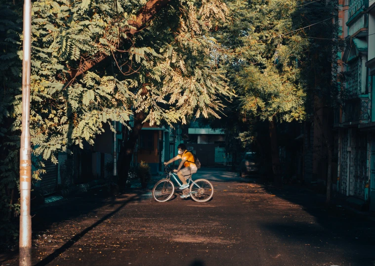 a woman riding on the back of a bike through a tunnel