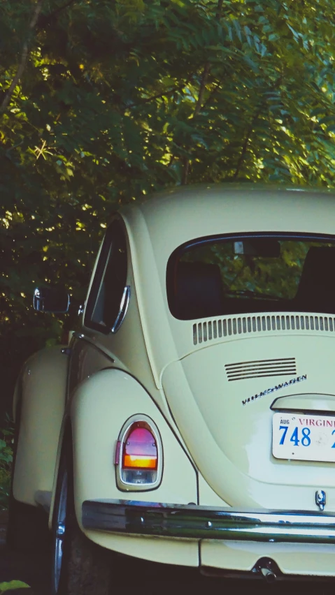 a vintage vw bug on display at a car show