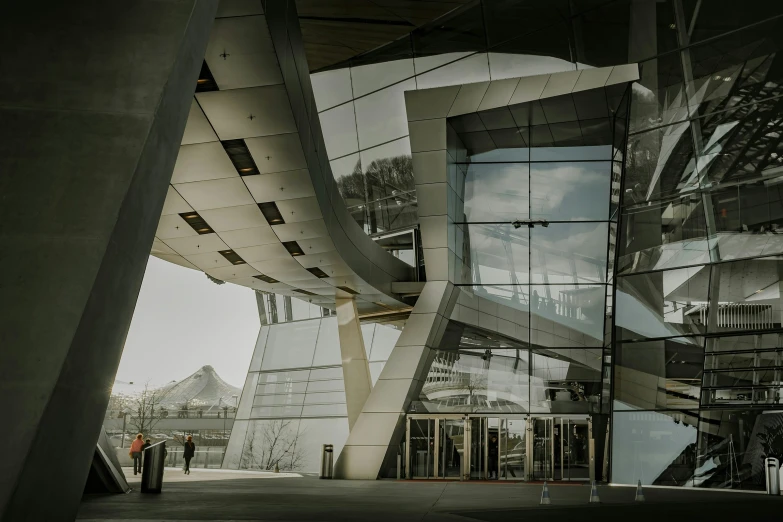 an abstract building with glass windows and people walking by