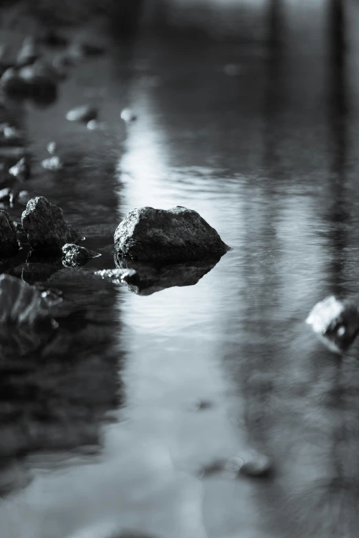 a rocky beach next to water and pebbles