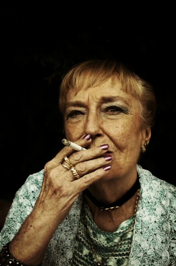 older woman smoking and making a face while sitting down