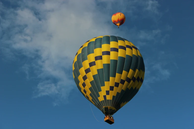 two  air balloons that are flying in the sky