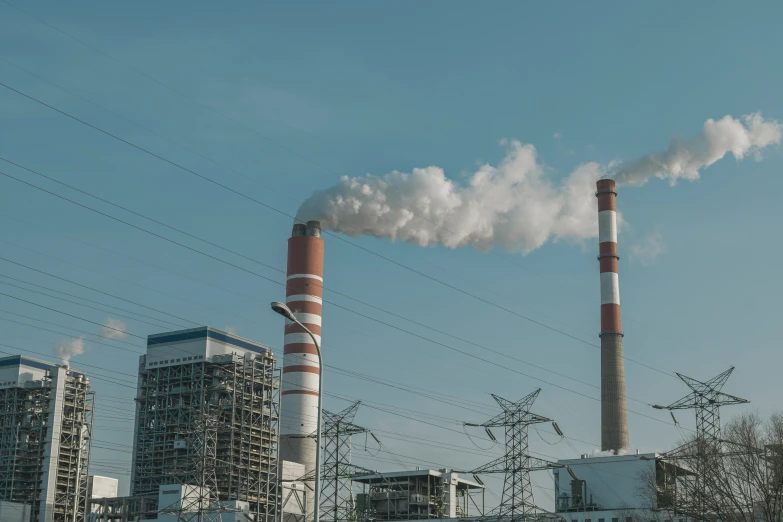 a factory with a tall stack of pipes