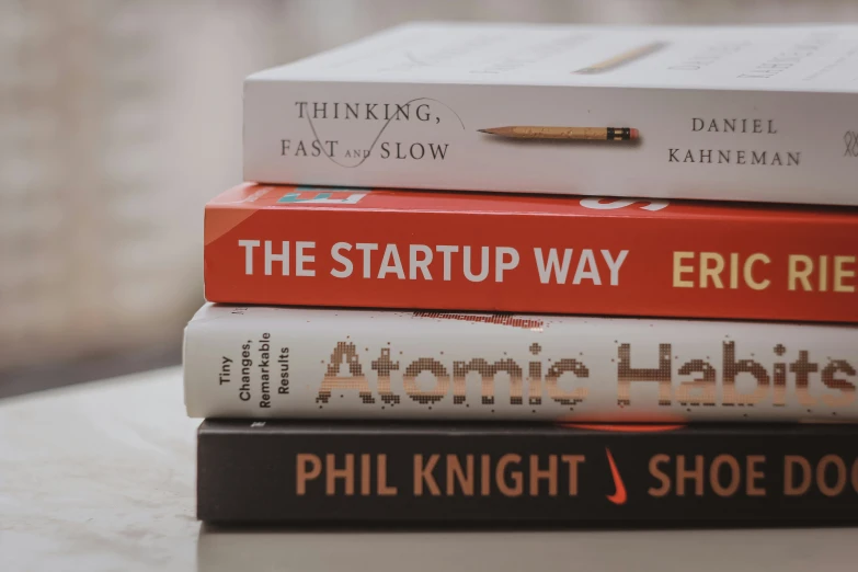 a stack of books sitting on top of a table