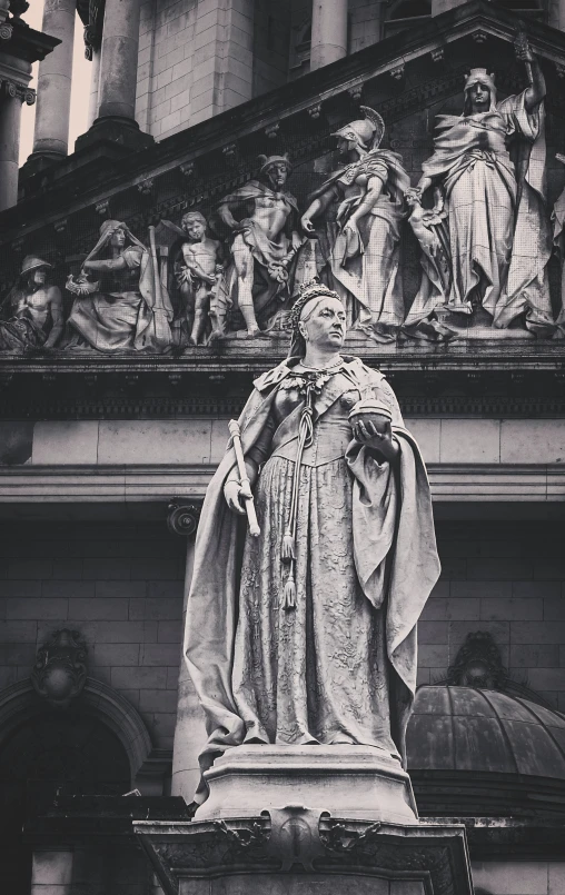 a statue stands next to the building in front of it