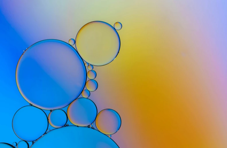 water bubbles are floating on a colored surface