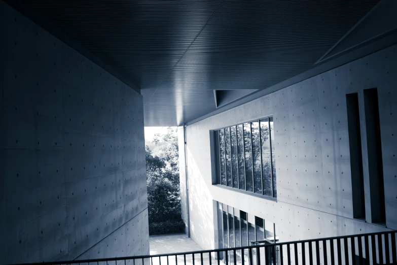 a room with a large windows next to the stairs