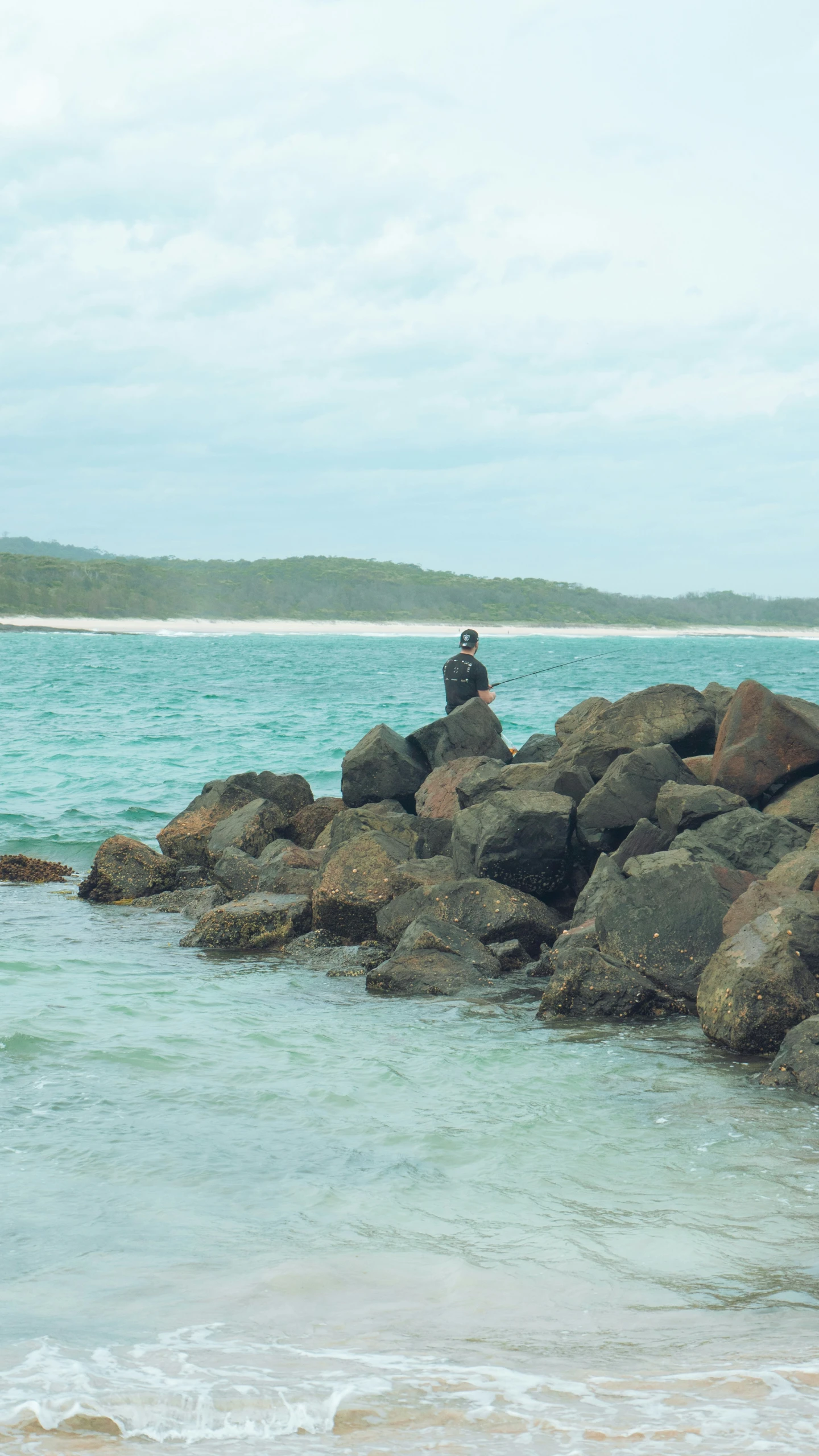 some people riding a wave on the rocky shore