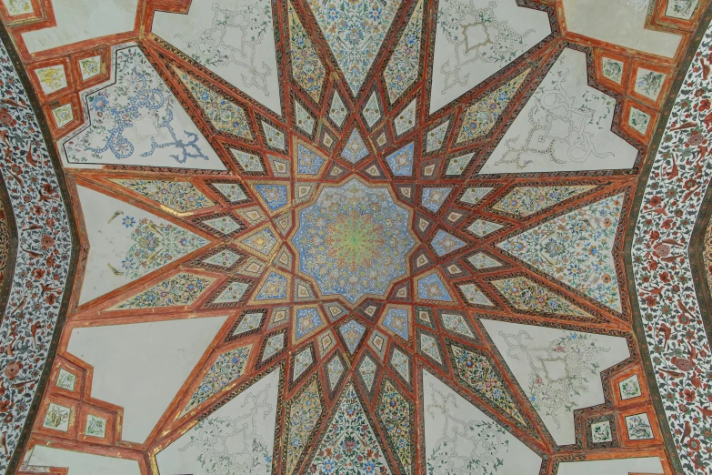 an ornately designed ceiling with a star motif