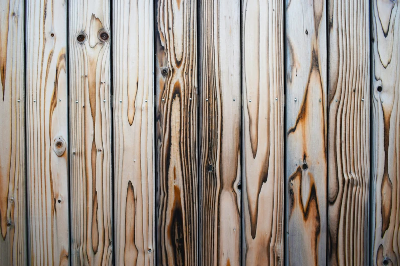 an old wooden plank fence with nails