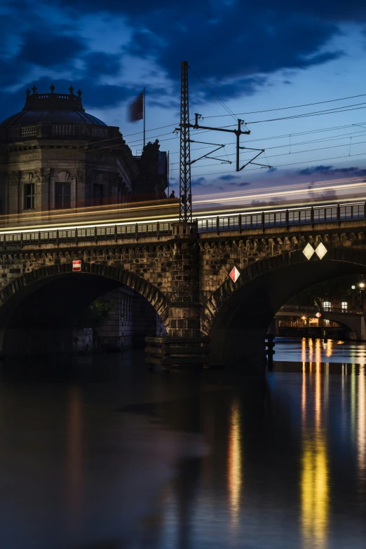 a bridge over water and a train on it