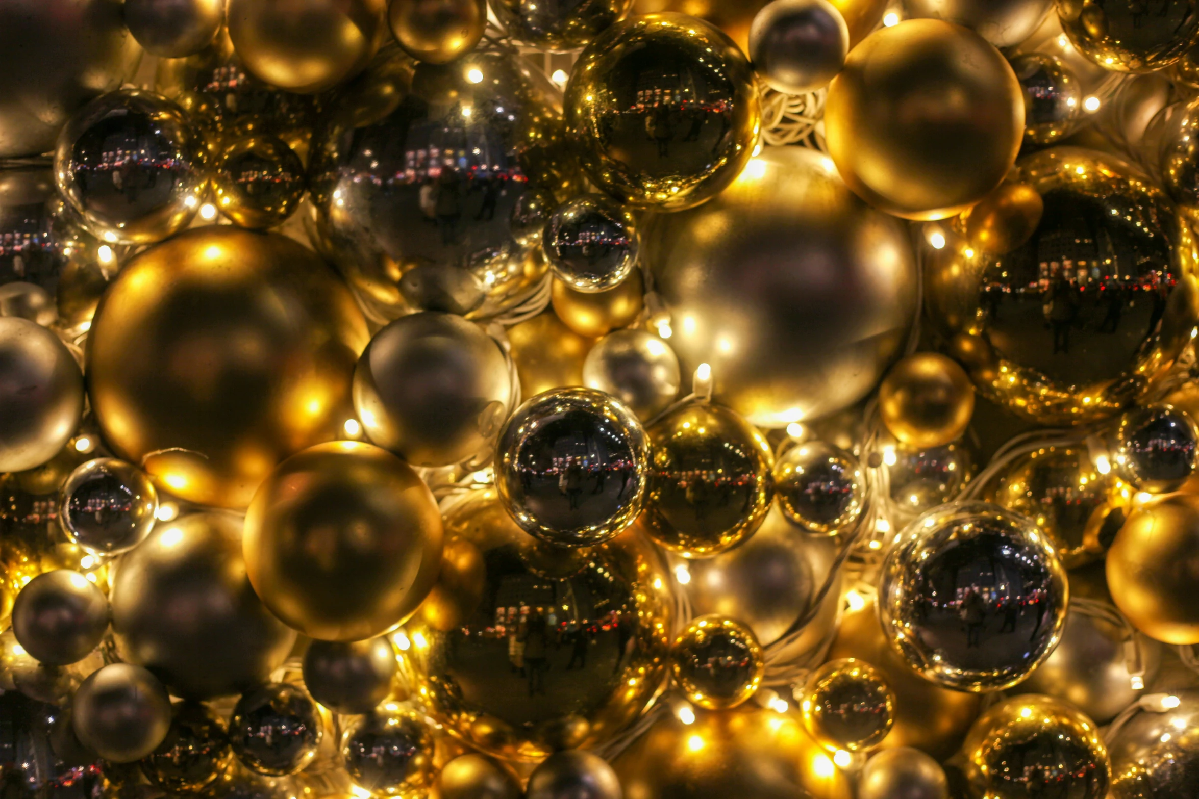 golden and silver spheres all over a dark background