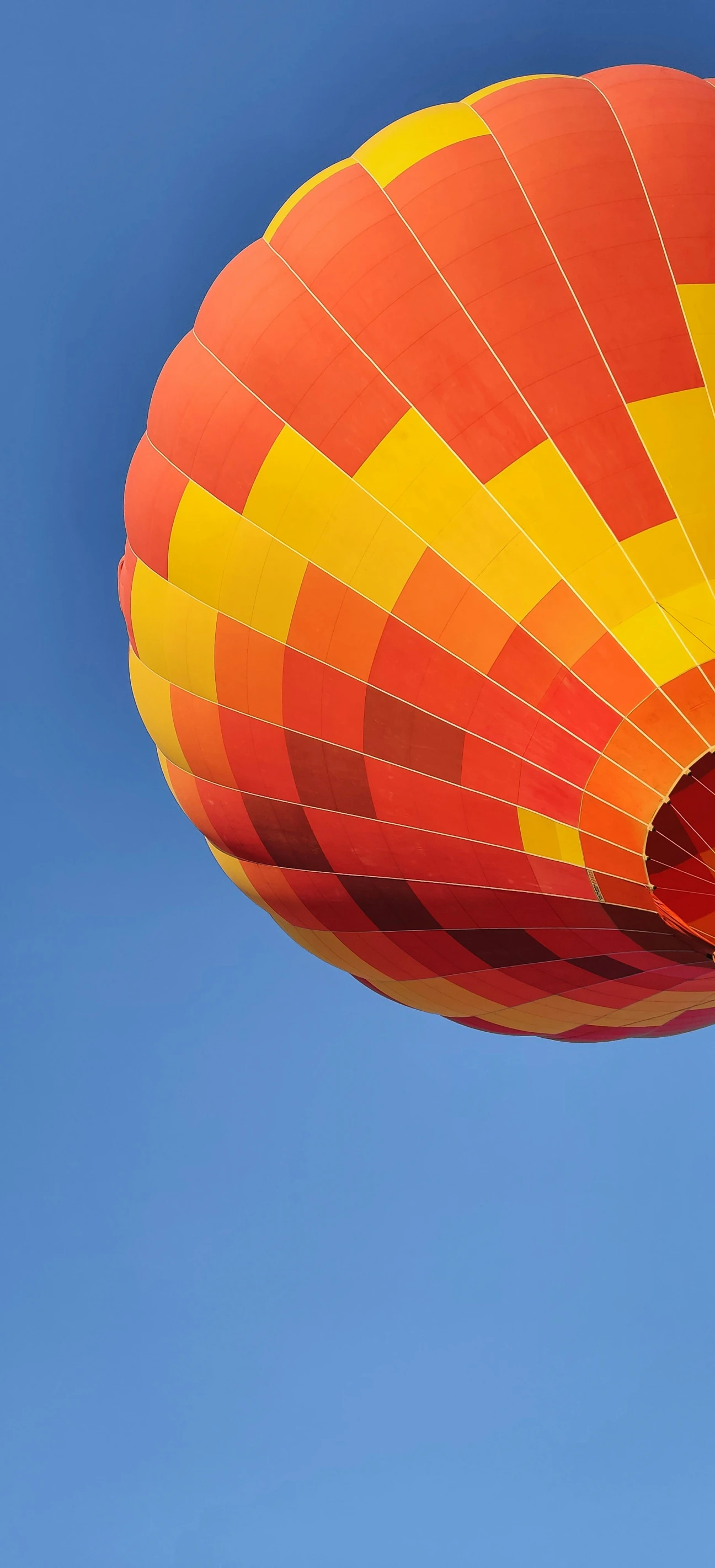 an orange and yellow  air balloon in the sky