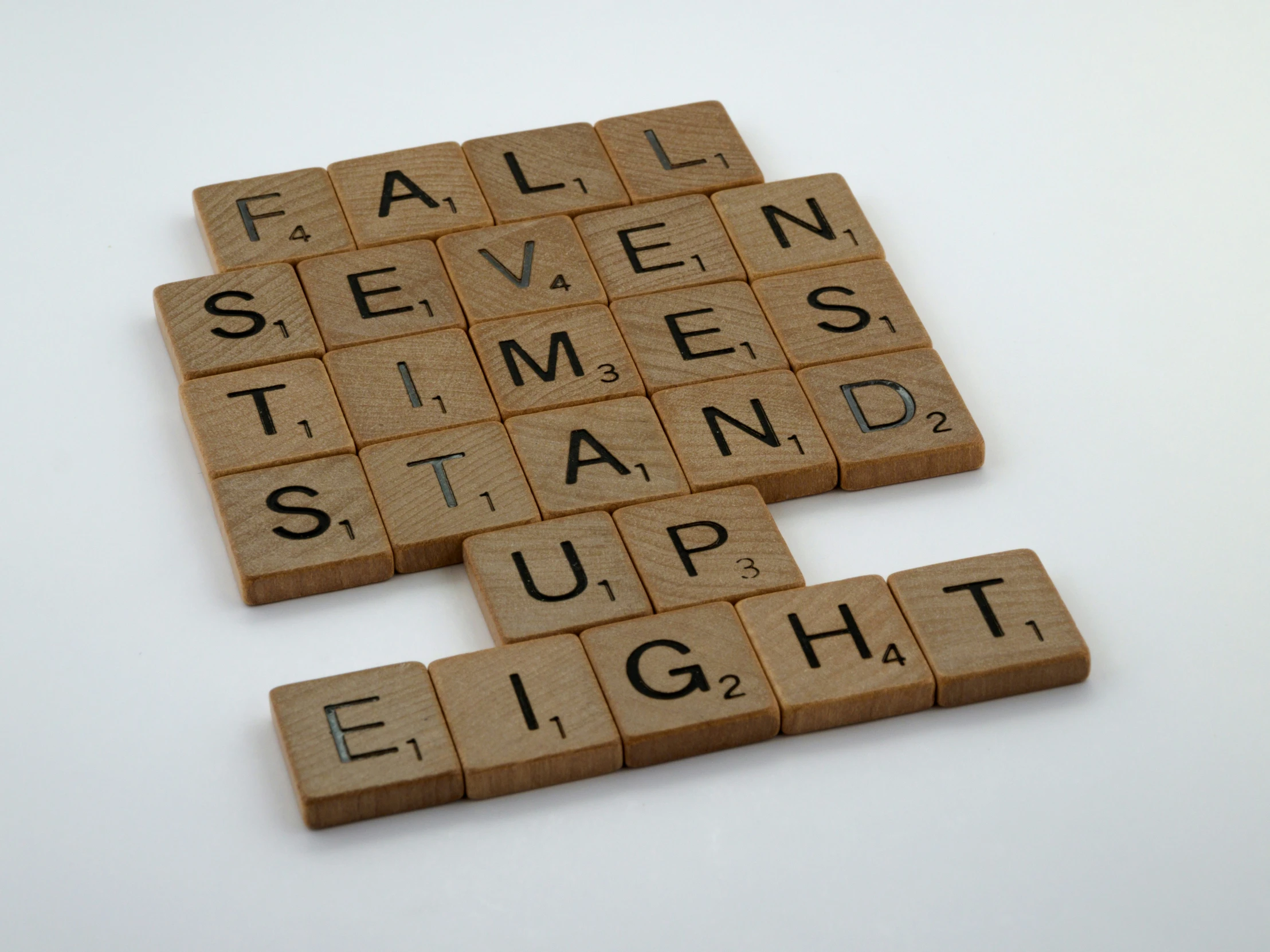 two scrabbles that spell out the words fall seven times stand up eight four times