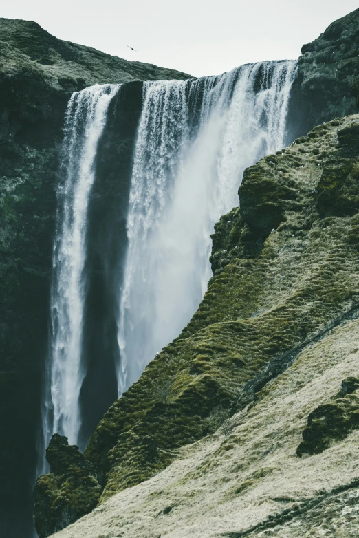 the base of a large waterfall with water falling down