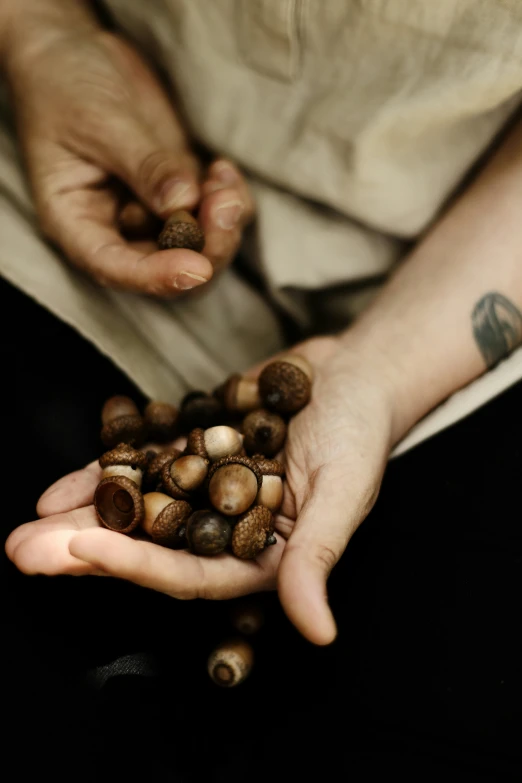 someone's hands holding nuts from their hand