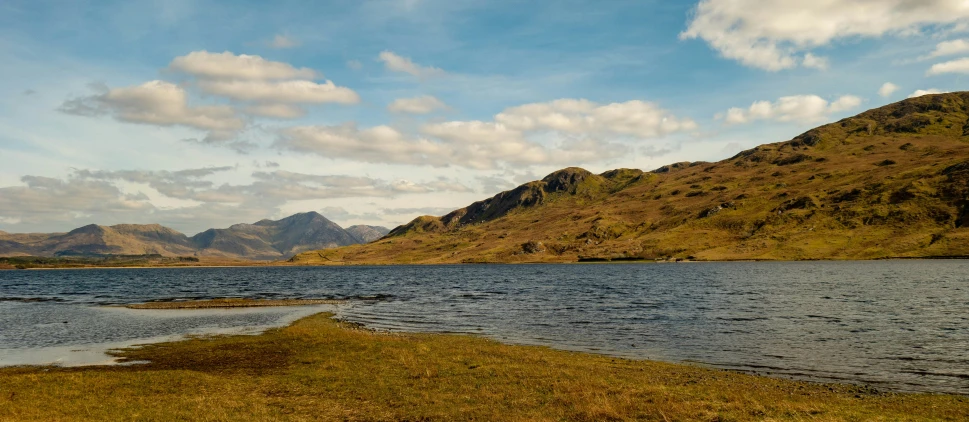 a couple of very large mountains that are next to a lake