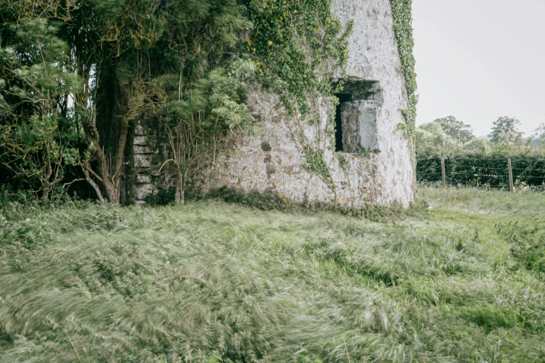 an old, run down stone house with a window