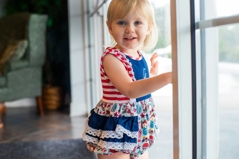 a little girl that is standing up by a door