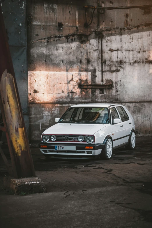 a white car is parked in front of a building