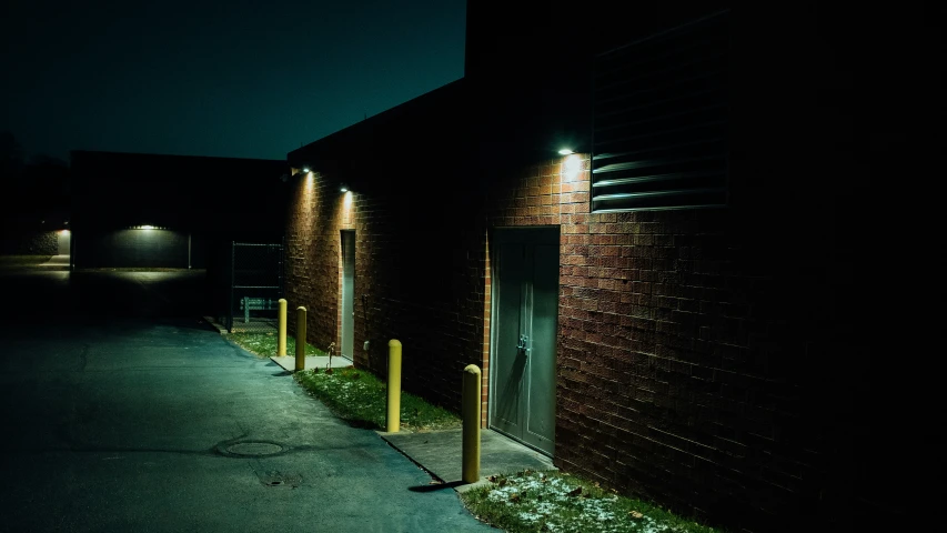 two brown brick buildings are shown at night